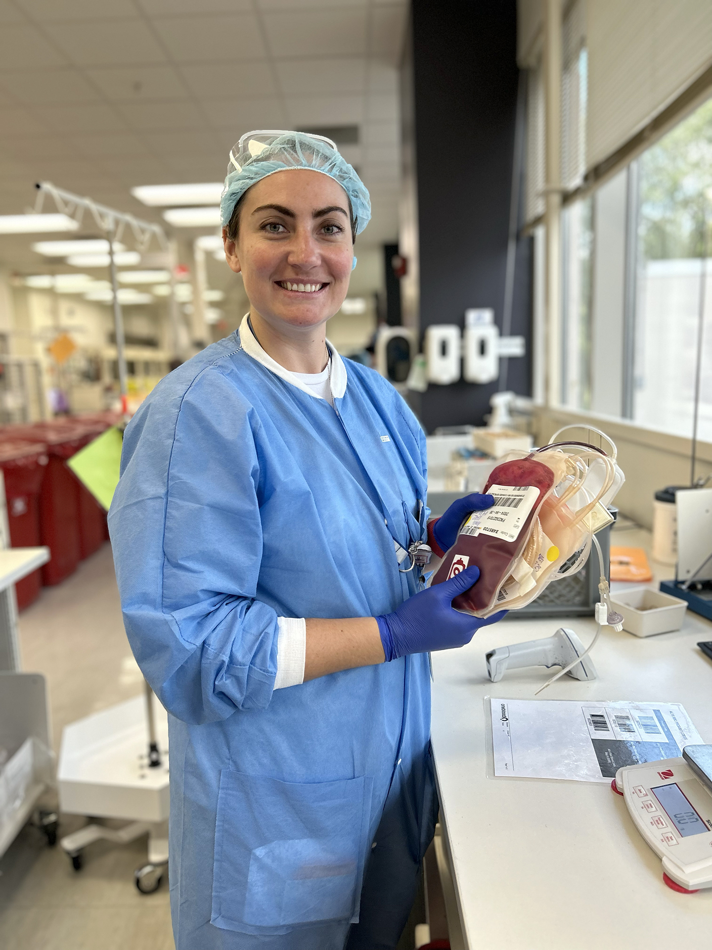Leesa a Biologics assistant holding a unit ready to be process at a OneBlood lab